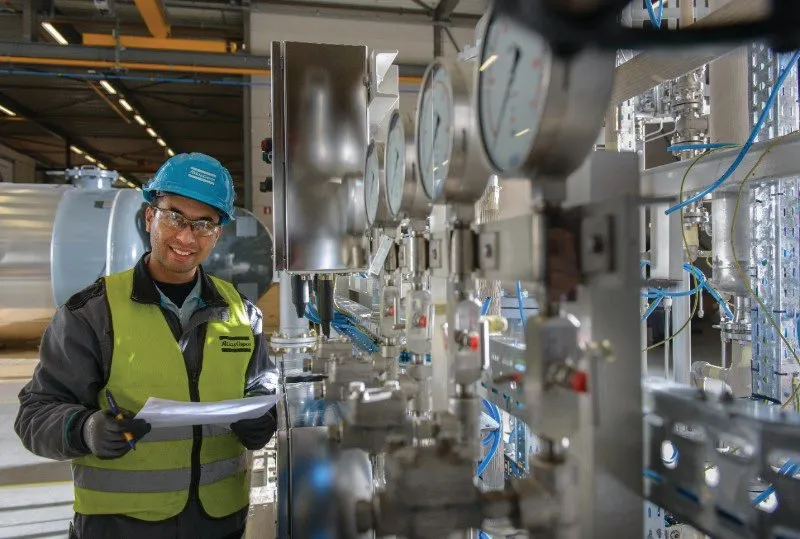 An engineer with a clipboard in an industrial plant (photo: Atlas Copco)