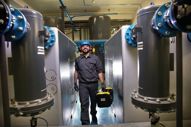 A technician walking between compressors (photo: Atlas Copco)