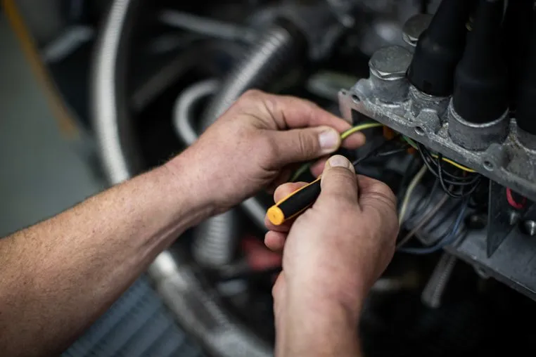 Close-up of hands wiring an electrical component